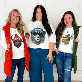 Women wearing game day graphic tees and crewnecks in regular & curvy sizes from the Avery Mae Boutique.