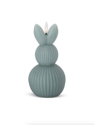 Muted green ribbed LED bunny candle with upright ears and flame-like top