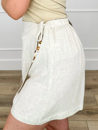 High-rise oatmeal skort with drawstring waist and side bead-tie detail