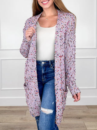 Knit long-sleeve cardigan with open front, speckled purple and pink over white