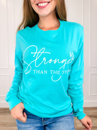 Seafoam green long-sleeve graphic cotton tee with 'Stronger' and 'THAN THE STOR' print