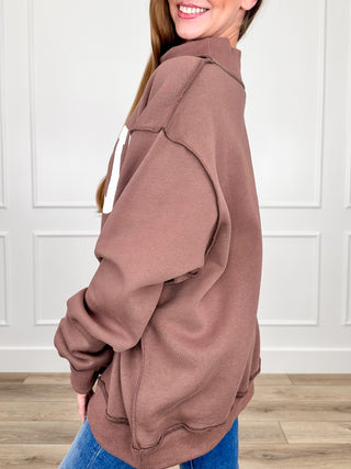 Brown mock-neck long-sleeve sweatshirt shown in side view
