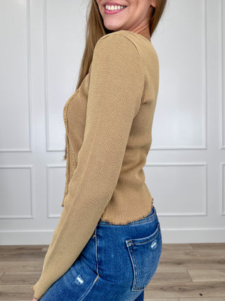 Tan long-sleeve cropped knit top, side view