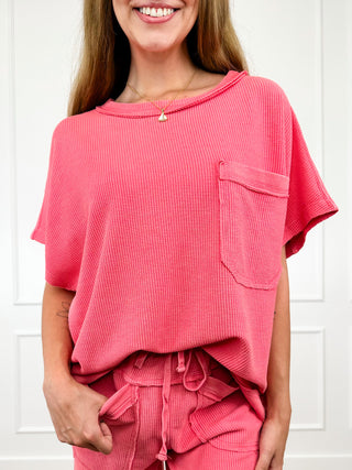 Pink cotton-blend short-sleeve top with crew neck and chest pocket