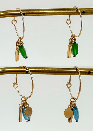 Gold hoop earrings with green and blue drop charms, small bar and round disk accents.