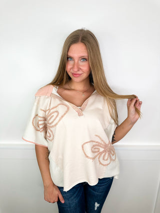 Cream cotton-blend short-sleeve top with butterfly embroidery and V-neck