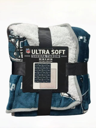 Sherpa throw blanket, dark teal with NFL Ultra Soft Sherpa Throw label and black straps