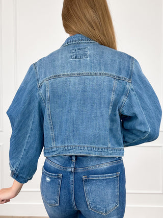 Medium-wash cropped denim jacket, back view with yoke seam, 3/4 sleeves