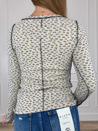 Oat knit long-sleeve top with small black print, back view with seam