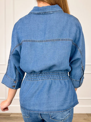 Blue denim short-sleeve button-up top back view with drawstring waist and yoke