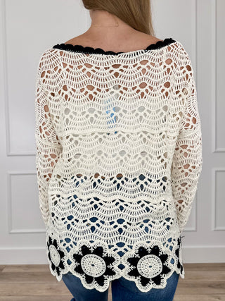 Cream crochet knit sweater with open knit back, long sleeves, black flower trim