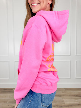Pink long-sleeve hoodie with front graphic, kangaroo pocket, drawstring hood