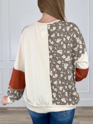 Colorblock knit long-sleeve top, cream sleeves with rust block and gray floral back panels