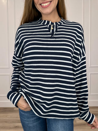 Knit long-sleeve top in navy and white stripes with buttoned half-placket