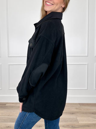 Black long-sleeve shacket with flap chest pockets and button front, side view