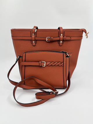 Cognac brown faux leather shoulder bag with top flap, front pocket, and crossbody strap