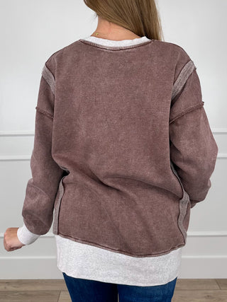 Women's brown long-sleeve V-neck pullover top, back view with contrast white hem