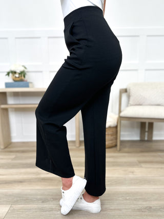 Black high-rise Avery Mae bottoms with wide-leg cut and smooth, fitted waistband
