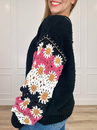 Dark knit long-sleeve sweater with contrast floral sleeve panels and rounded neckline