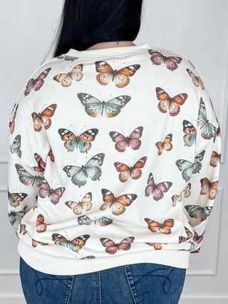 Cream long-sleeve crewneck sweatshirt with full butterfly print, back view
