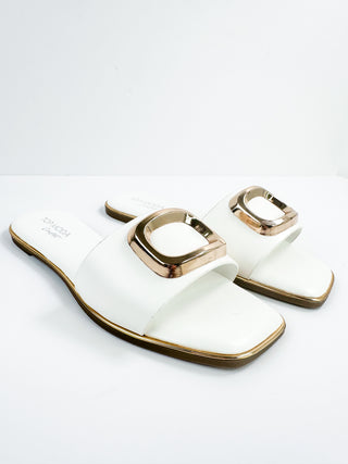 White slide sandals with square gold buckle straps