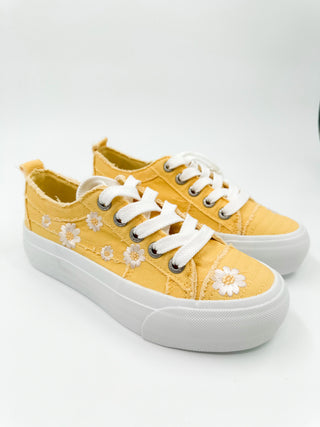 Yellow canvas sneakers with white laces and daisy embroidery, low-top