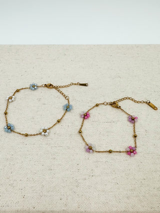 Gold-tone chain bracelets with blue and purple flower beads, adjustable clasp