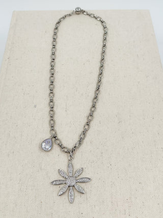 Silver daisy pendant necklace with dangling flower and small round stone charm