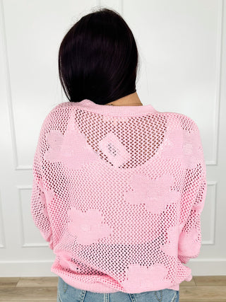 Pink knit button-up cardigan, back view with long sleeves and button front