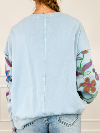 Light blue cotton long sleeve top with plain back and colorful sleeve prints