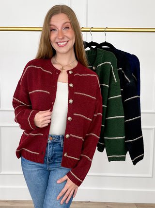 Wine red button-up knit cardigan with long sleeves and cream striped front pockets