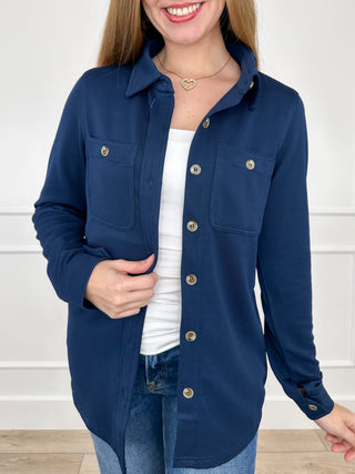 Blue ribbed long-sleeve button-up top with pointed collar, front buttons, chest pockets