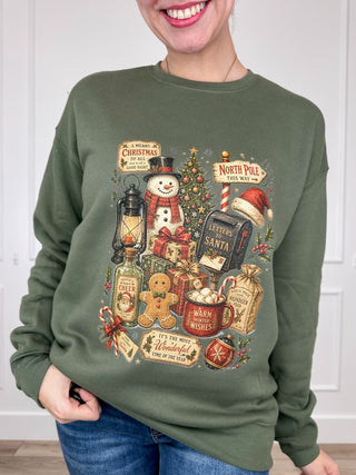 Green long-sleeve crewneck sweatshirt with a colorful Christmas montage graphic