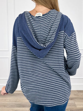 Blue striped hooded button-up long-sleeve top with kangaroo pocket, back view