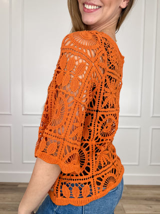 Orange crochet short-sleeve top with allover circular lace pattern