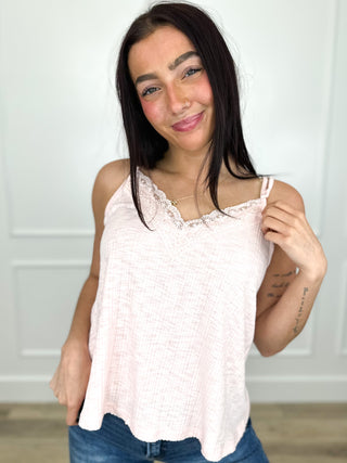 Cream ribbed tank top with lace-trim scoop neckline and curved hem