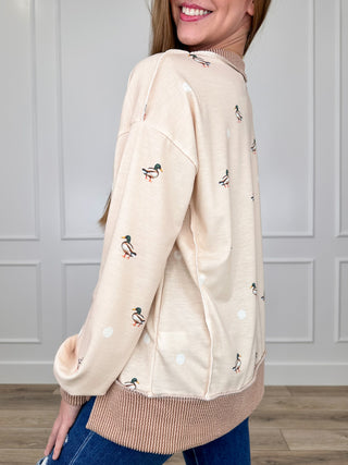 Cream long-sleeve top with mallard print, ribbed cuffs and hem trim