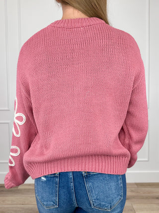 Pink long-sleeve knit sweater back view, ribbed crew neck and hem