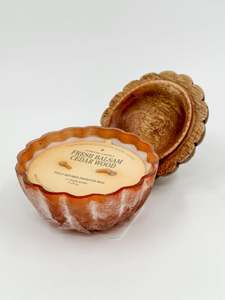 Pumpkin wax candle with label "FRESH BALSAM CEDAR WOOD" and scalloped lid