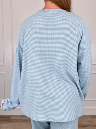 Light blue long-sleeve crewneck top, back view, textured waffle knit