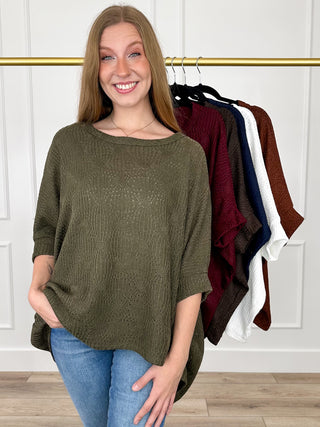 Olive green knit short-sleeve poncho top with scoop neckline