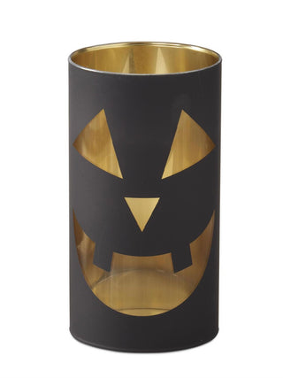 Black glass candle slip cover with gold jack-o-lantern face cutouts