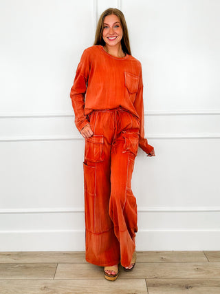 Rust orange cotton long-sleeve top with chest pocket and relaxed fit