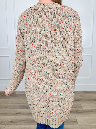 Tan knit long-sleeve cardigan with speckled pattern, longer back hem
