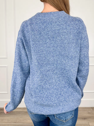 Blue knit long-sleeve sweater top back view with crew neck and ribbed hem