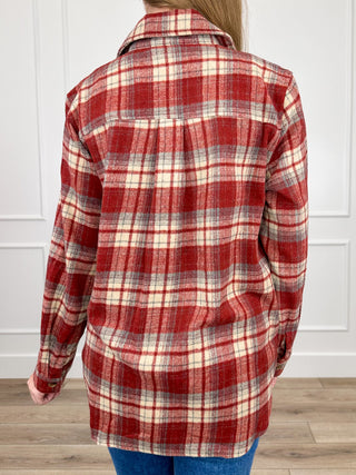 Brick red plaid flannel shacket back view, long sleeves, button-up style