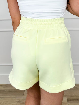 High-rise drawstring shorts, light yellow, front view with cuffed hem