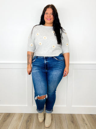 Light gray floral knit sweater and blue ripped skinny jeans with ankle boots