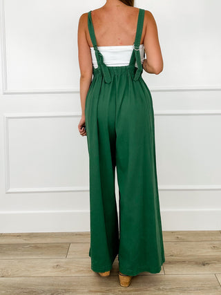 Green jumpsuit back with wide straps and tie detail over wide legs