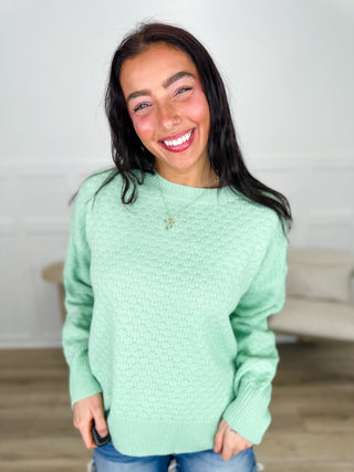 Light green textured knit long-sleeve sweater with crew neck and ribbed cuffs